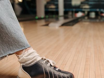 Close up of sports equipment on dark wooden floor.